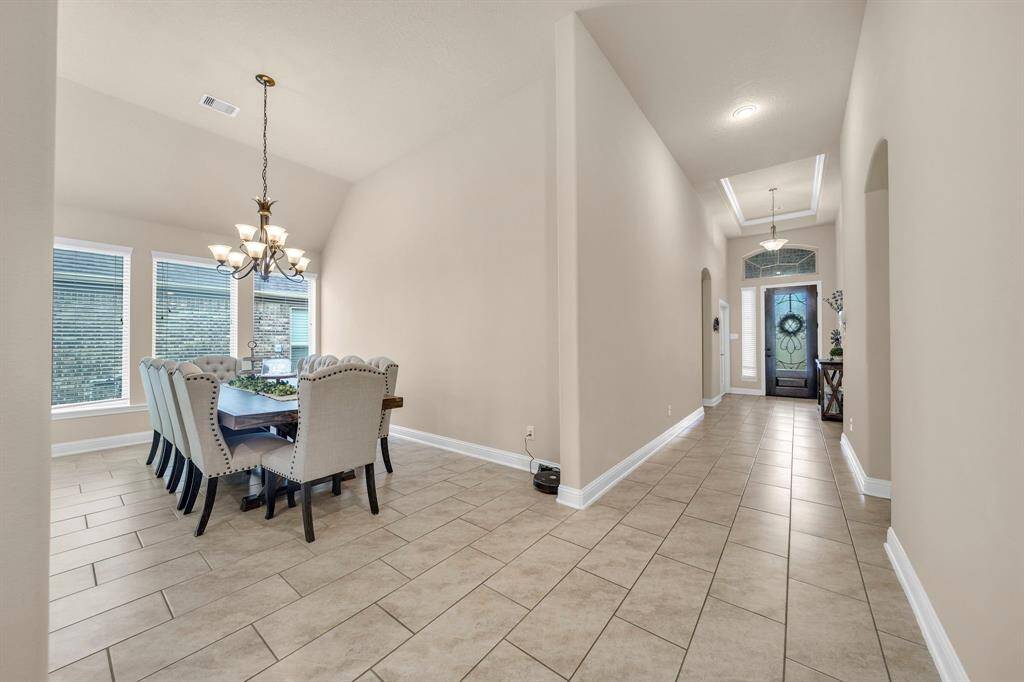 Entering the home you step into a grand foyer with soaring ceilings.