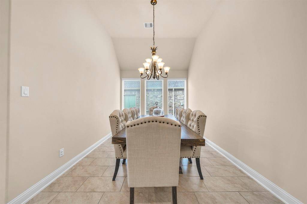 A formal dining room sits privately, offering generous space for hosting family gatherings