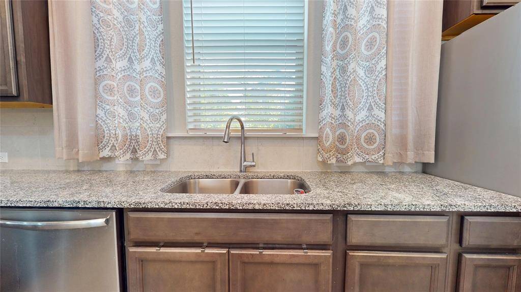 Bright kitchen with a sink overlooking a scenic window view.