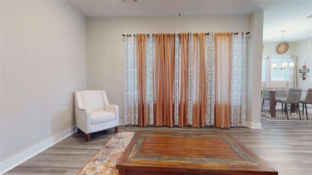 Spacious living area with large windows offering views of the patio and side yard.