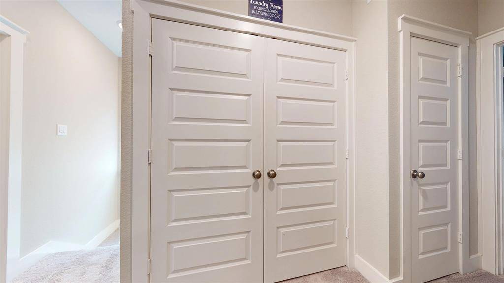 Efficient laundry area with convenient linen closet for organized storage.