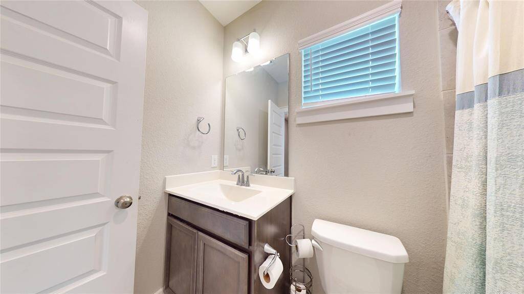 Modern and inviting guest bathroom with sleek finishes and ample natural light.