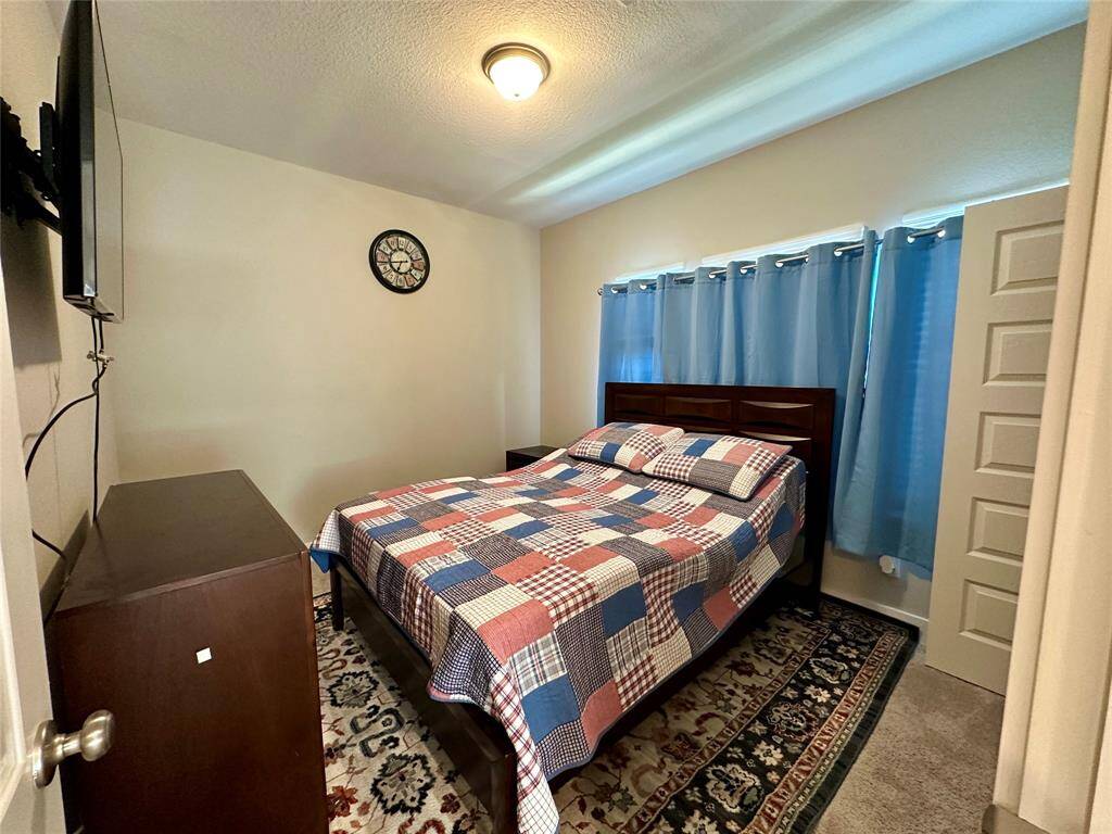 Cozy second bedroom with ample natural light and space for relaxation.