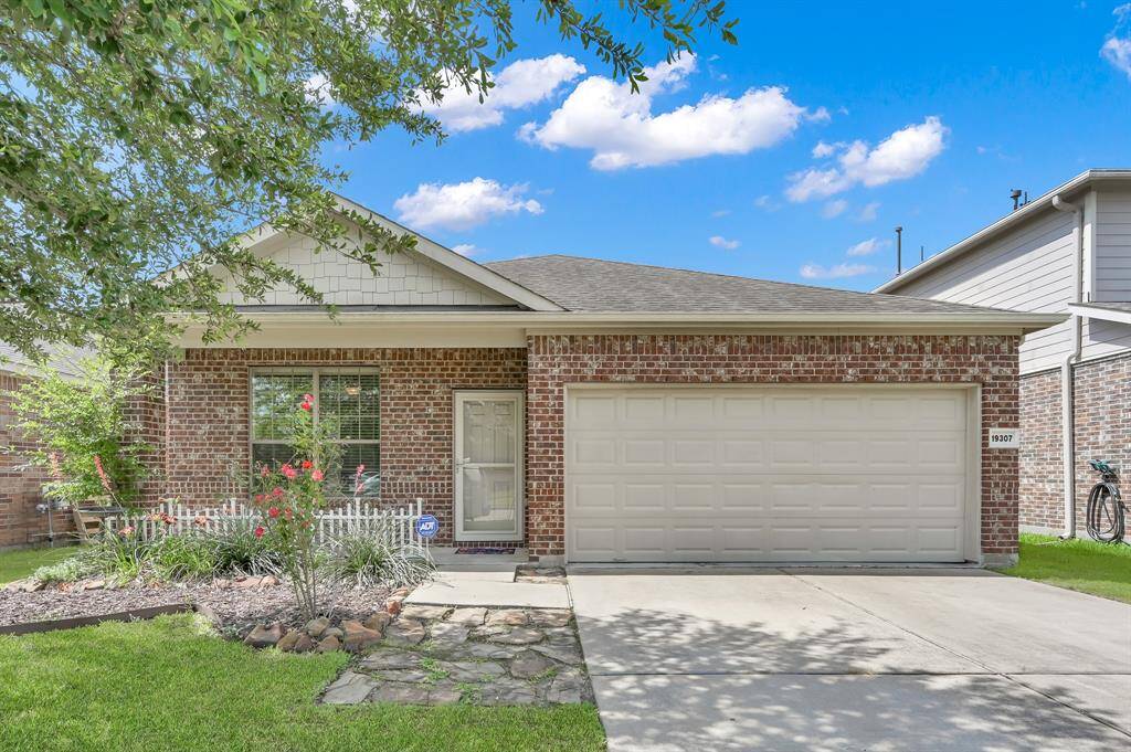 This charming brick home features a neat front yard with mature landscaping and a two-car garage. It offers a welcoming front covered porch providing excellent curb appeal in a peaceful neighborhood.