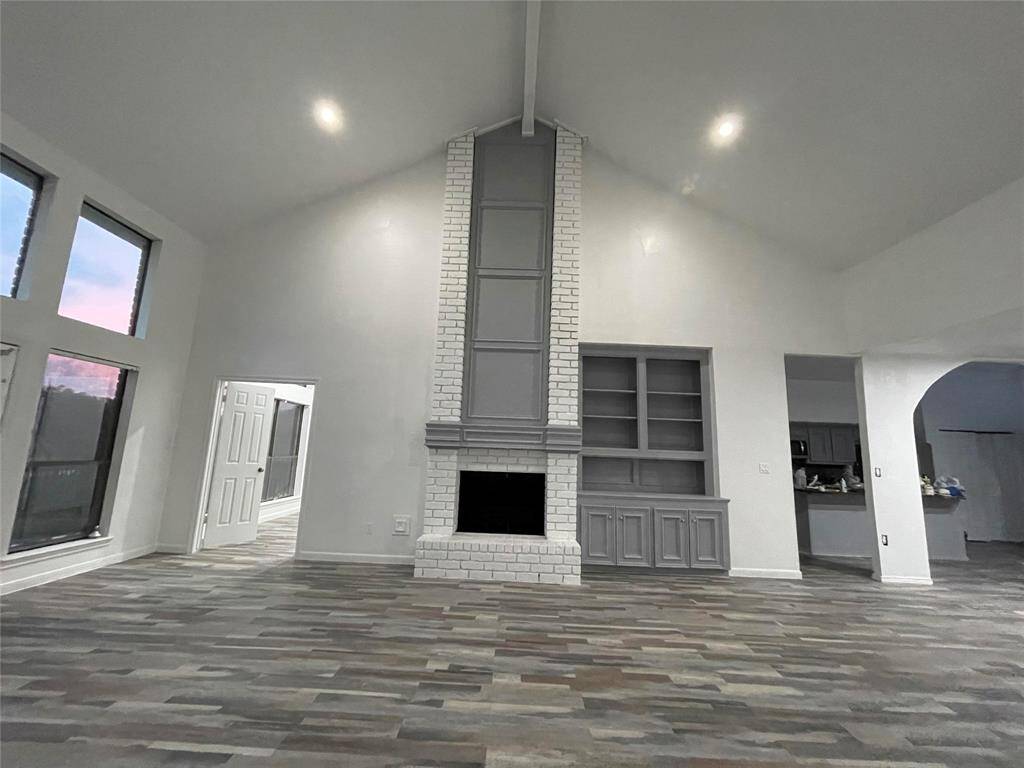 High ceiling family room with fireplace