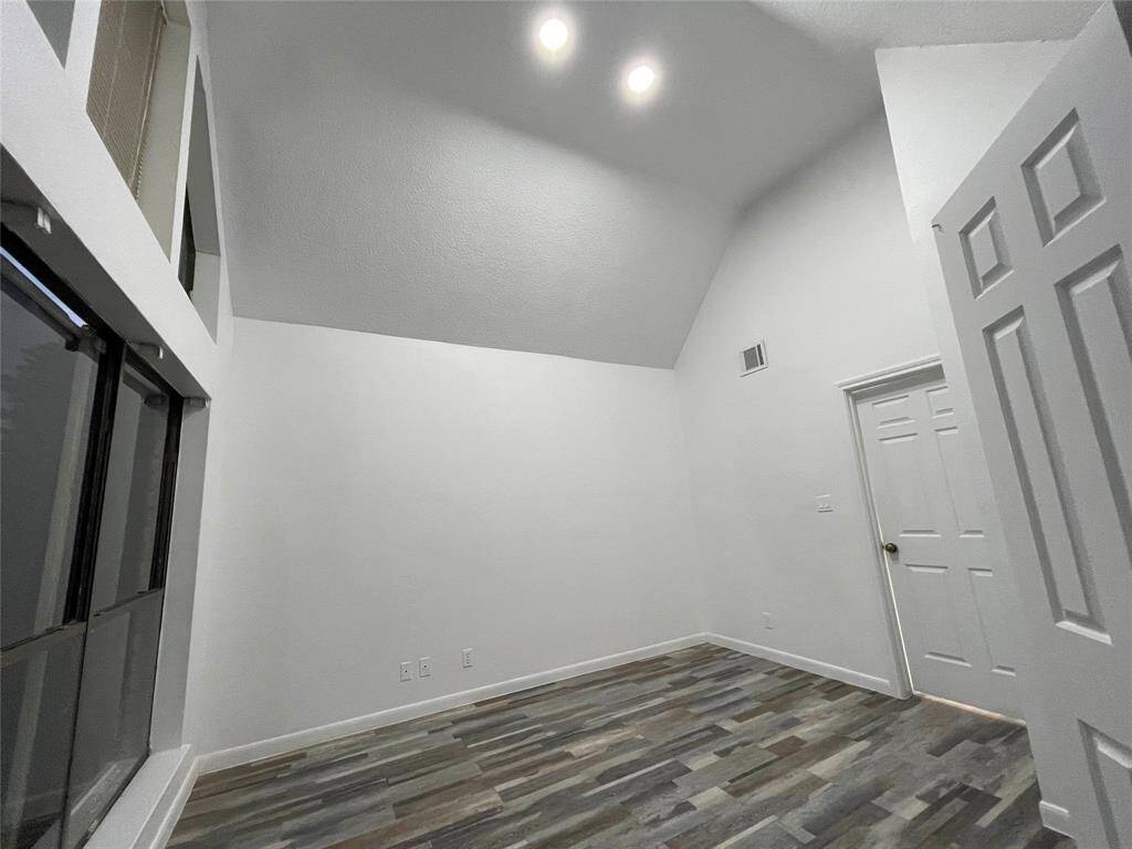 Another view of guest bathroom with high ceiling