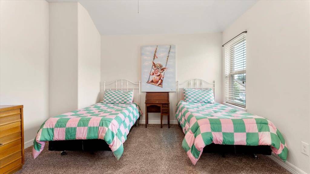 This bedroom can comfortably fit two twin beds, a nightstand, and a chest of drawers. With an en-suite bathroom, it serves as an ideal, clean, and welcoming guest retreat.