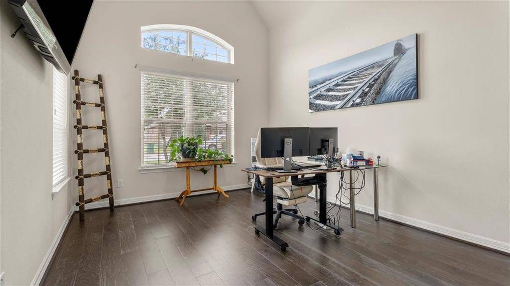 The downstairs suite is ideally suited for use as a home office or guest accommodations, featuring an en-suite bathroom. Soaring ceilings and a large windows flood the space with natural light, creating an inspiring and comfortable environment.