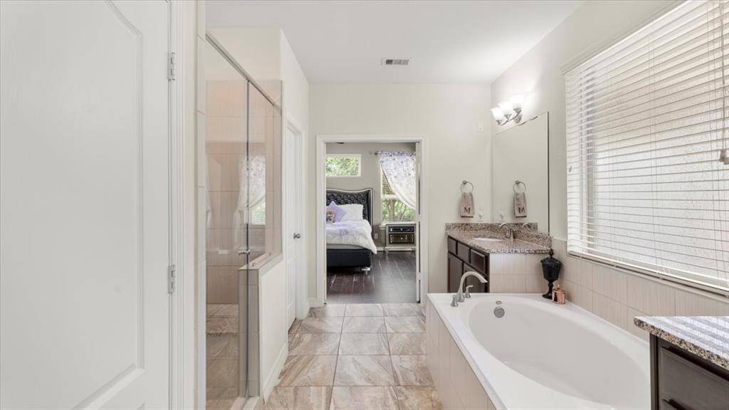 The large primary bathroom features a private water closet and direct access to a spacious walk-in closet.