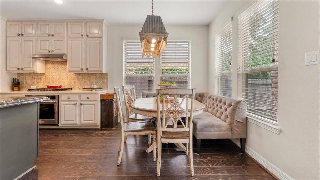 "The charming breakfast nook, ideally situated adjacent to the kitchen and living areas, offers a cozy space for casual dining. Its intimate setting is perfect for morning coffee, quick meals, or catching up with family and friends, seamlessly connecting daily living with comfort and style.