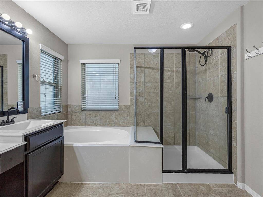 Shower and separate tub in the primary bathroom.