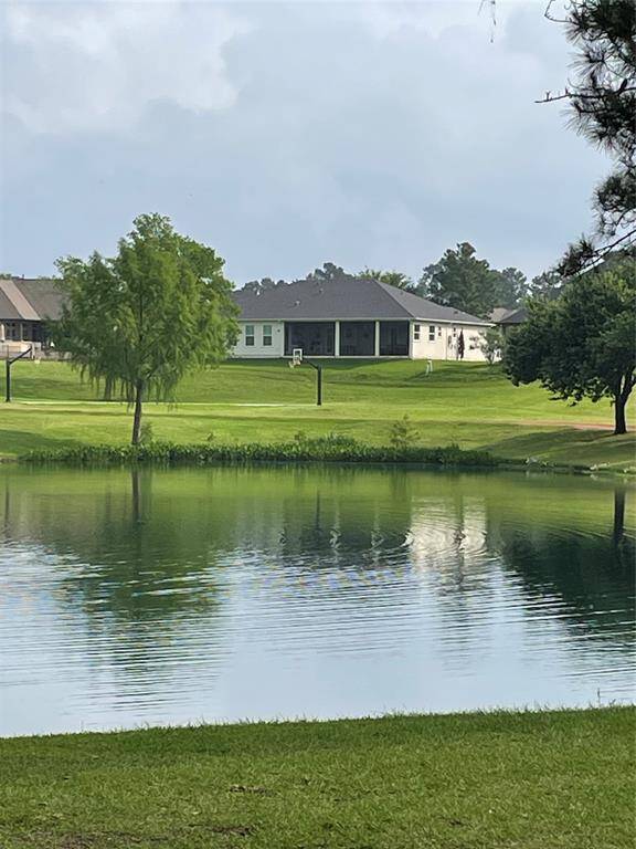 Back Elevation of the house with its amazing Covered Back patio overlooking the Pond and Park.