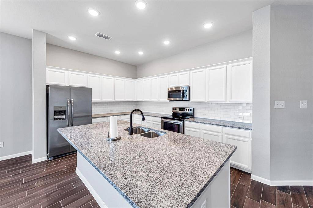 Here's another view showcasing the expansive island kitchen.