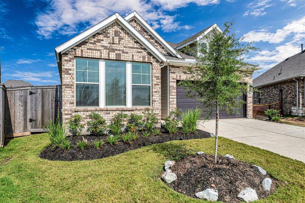 This all-brick home boasts a professionally manicured yard, adding to its charm and curb appeal.
