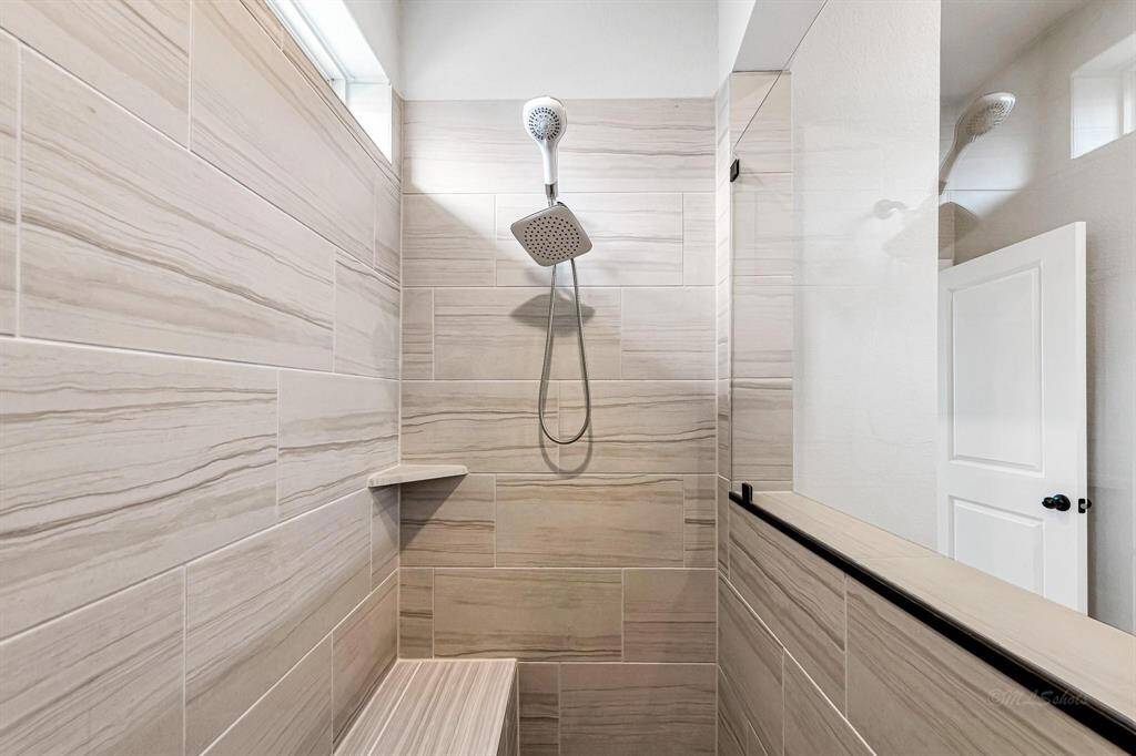 Here's another view to showcase the size and spaciousness of this shower. The tile work is beautifully done, matching the rest of the home with its gray and white tones.