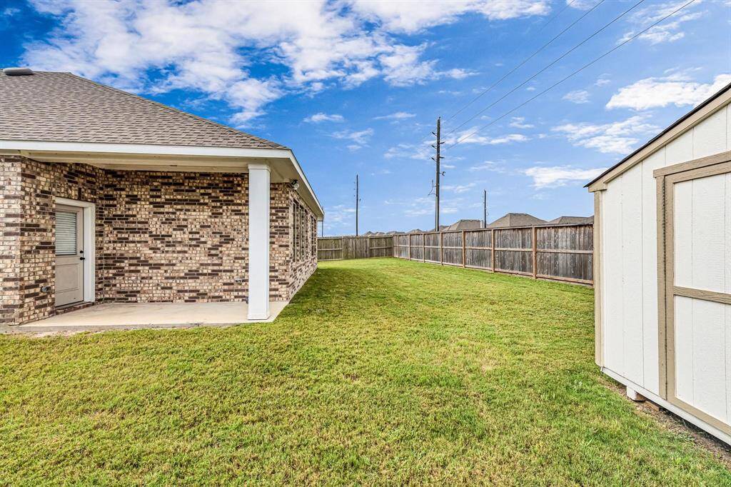 Here's another view showcasing the spacious yard that this home offers.