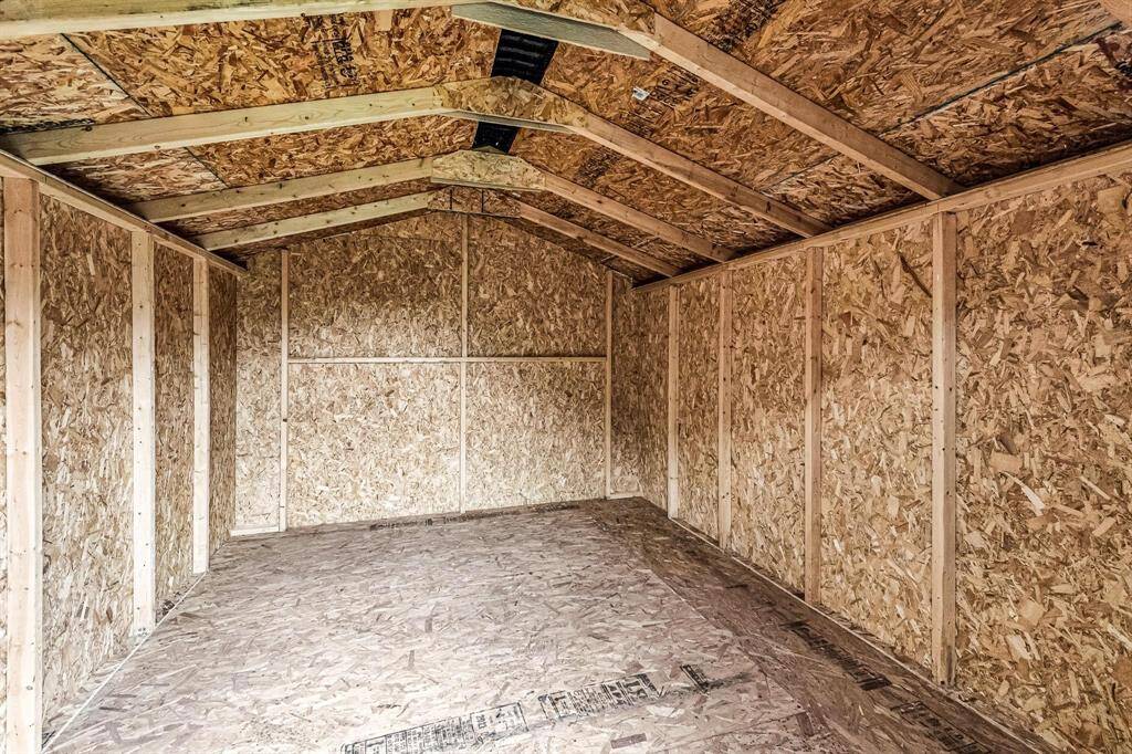 Inside the huge shed, you'll find ample space for storage or setting up a workshop for your hobbies.
