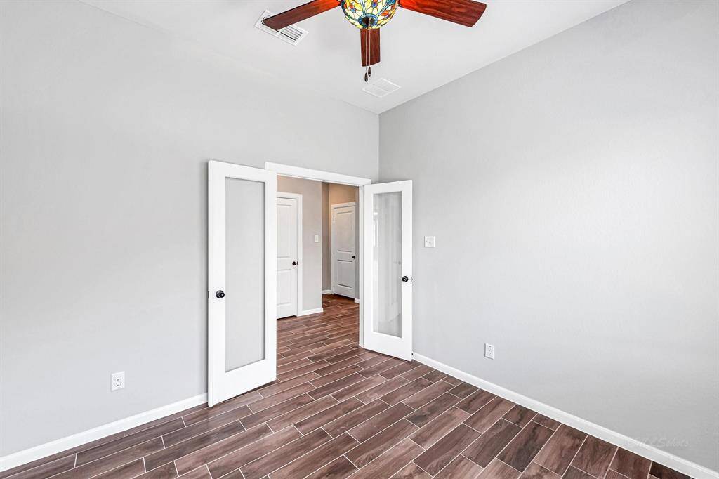 Here's another view showcasing the spaciousness of the home office, accentuated by the high ceilings.