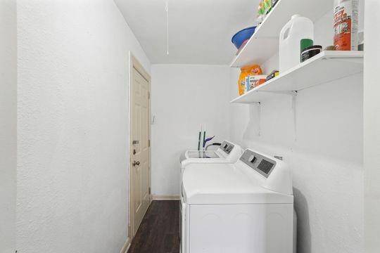 Utility room with washer and dryer included