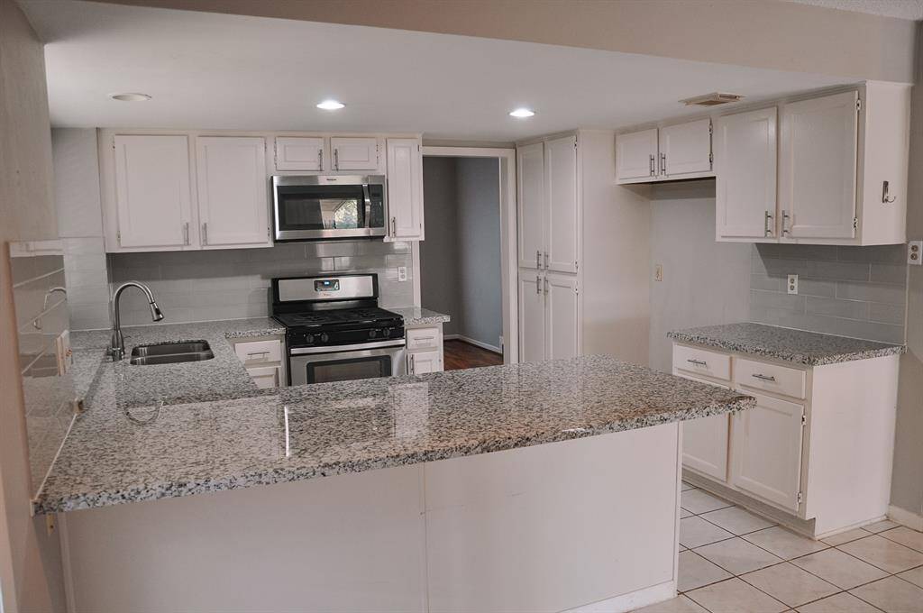 Open kitchen with stainless steel appliances