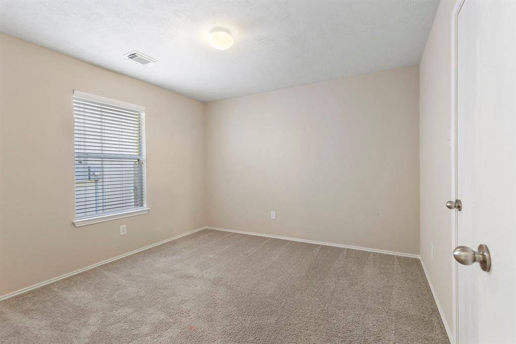 Secondary bedroom #2 has carpet and neutral paint.