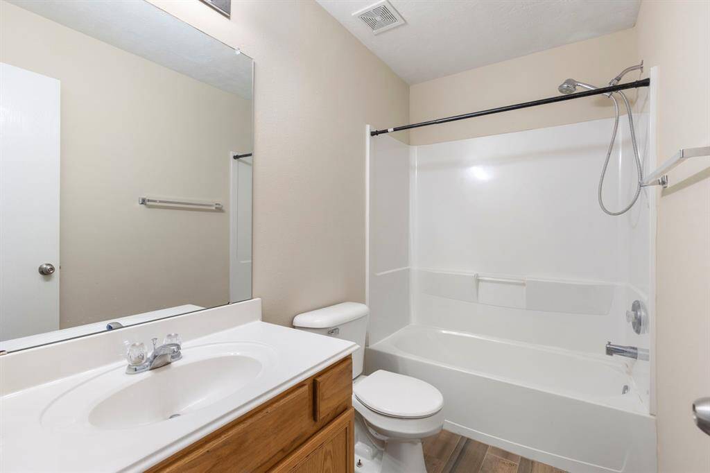 A full bath that can be shared by the secondary bedrooms has cultured marble, shower tub combination and tile flooring.