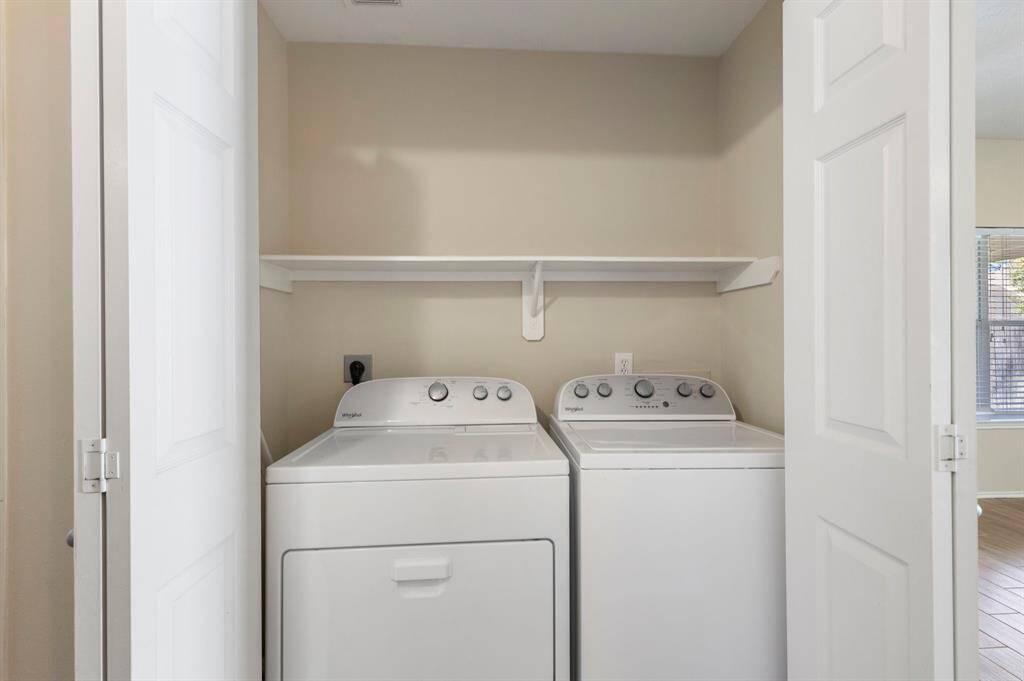The laundry room has additional storage - clothes washer and dryer included!