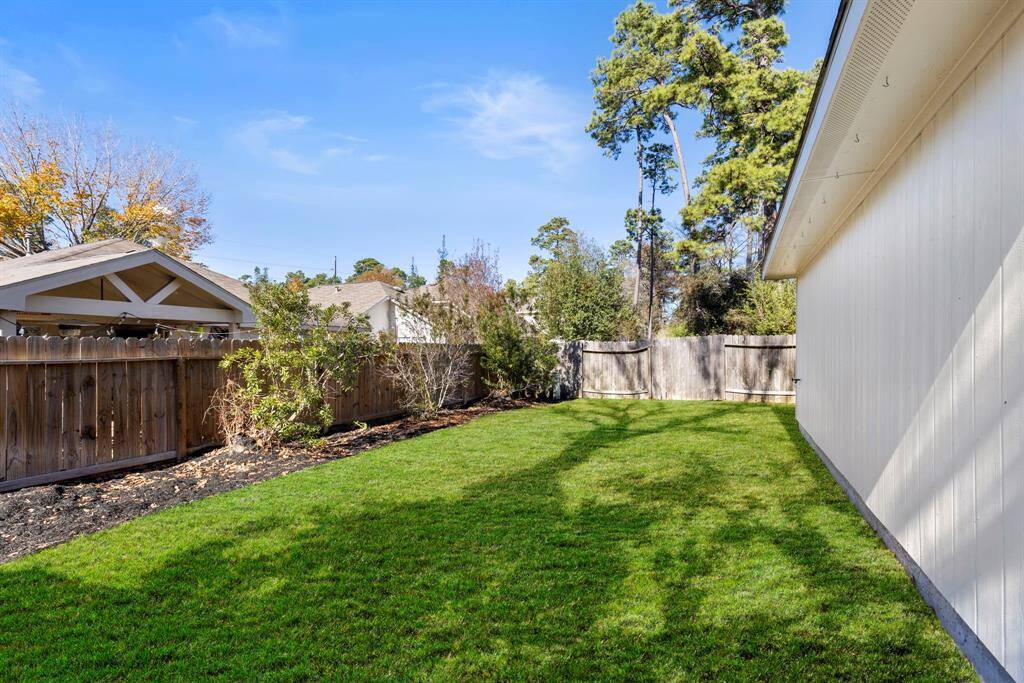 The back yard is lined with mature trees and plenty of green space!