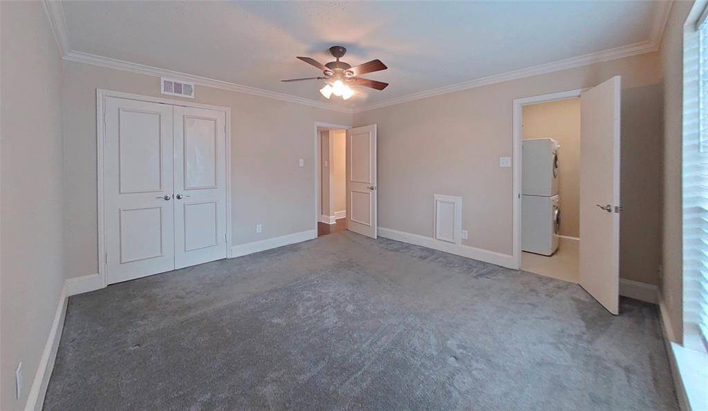 The spacious bedroom has two closets - the second closet includes a stackable washer and dryer for your convenience!