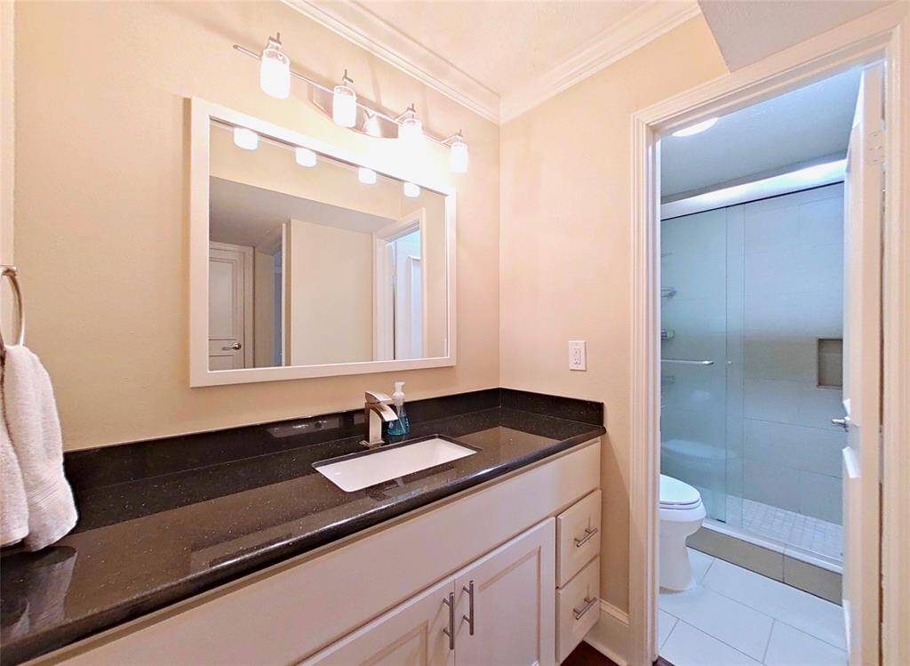 The bathroom features granite counters and ample storage space!