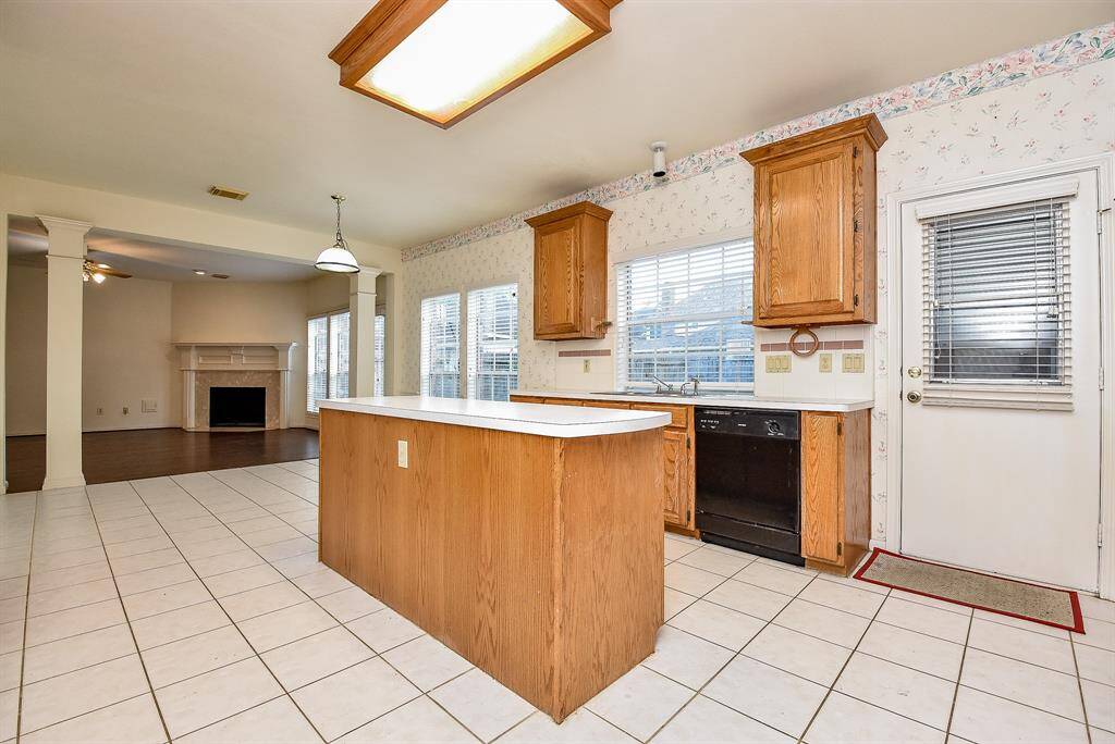 This kitchen combines functionality and style, featuring modern appliances and ample counter space for cooking and entertaining. Its open layout ensures easy flow into adjacent living areas.