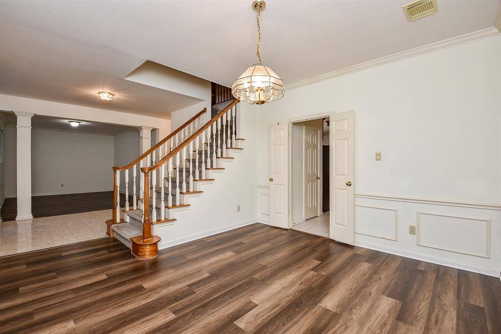 This inviting dining room, positioned at the front of the house, offers a seamless flow into the adjacent kitchen. It features ample natural light and provides an ideal space for both formal dining and casual meals, perfectly connecting to the culinary heart of the home for ease of entertaining and everyday living.