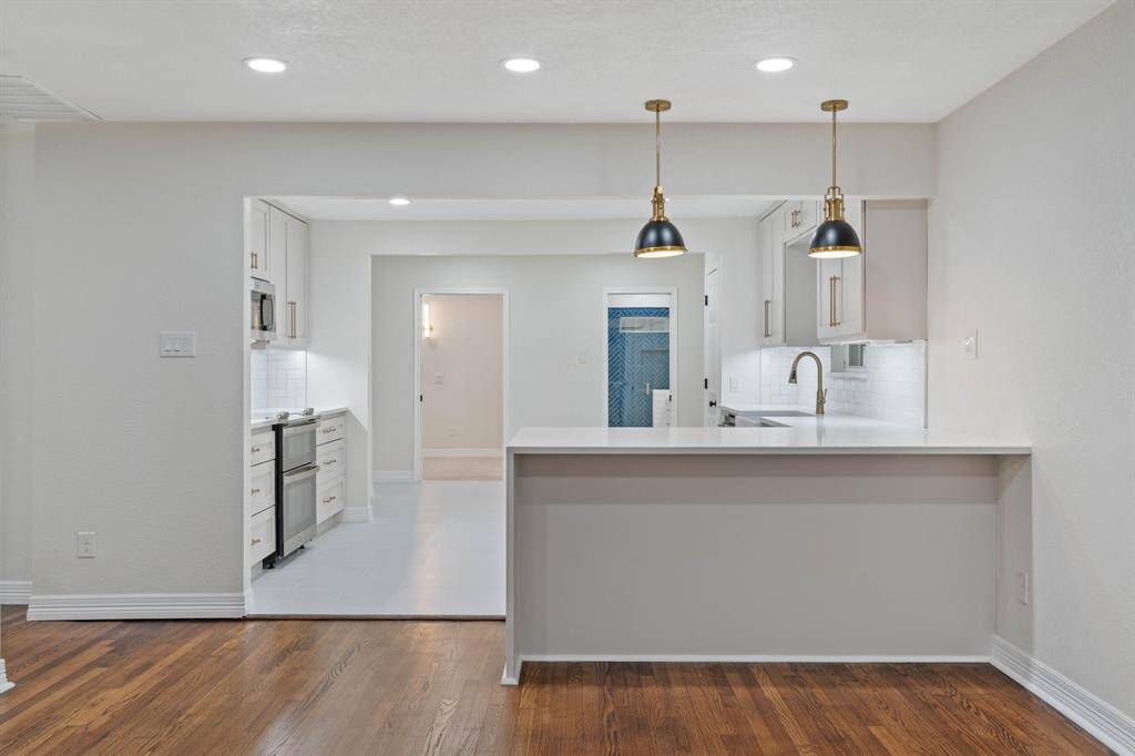 Breakfast bar with waterfall quatz countertop.
