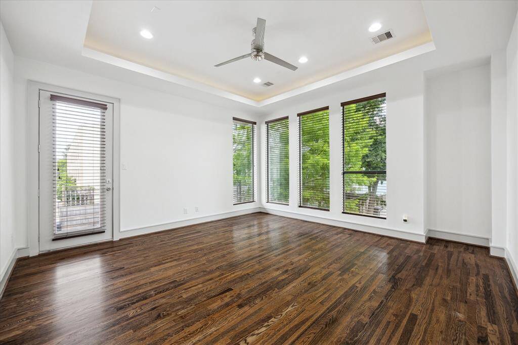 Primary Bedroom, with tree top views.  Hardwood floors