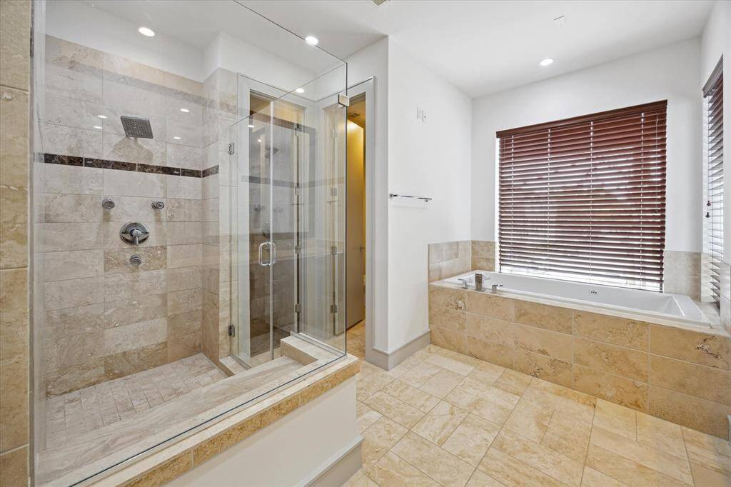 Primary bathroom, large walk in shower, and seperate jetted spa tub.