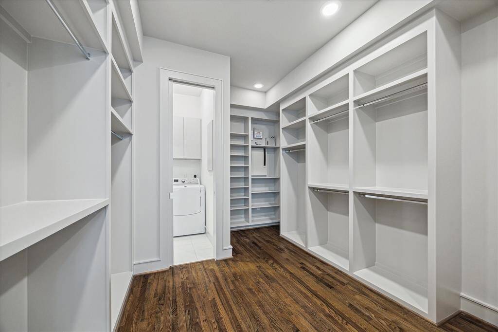 Primary closet with custom cabintery.