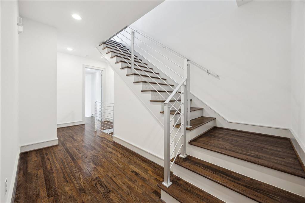 Stair landing and stairs to the 3rd floor.  Note hardwood floors and hardwood stair steps/treads.
