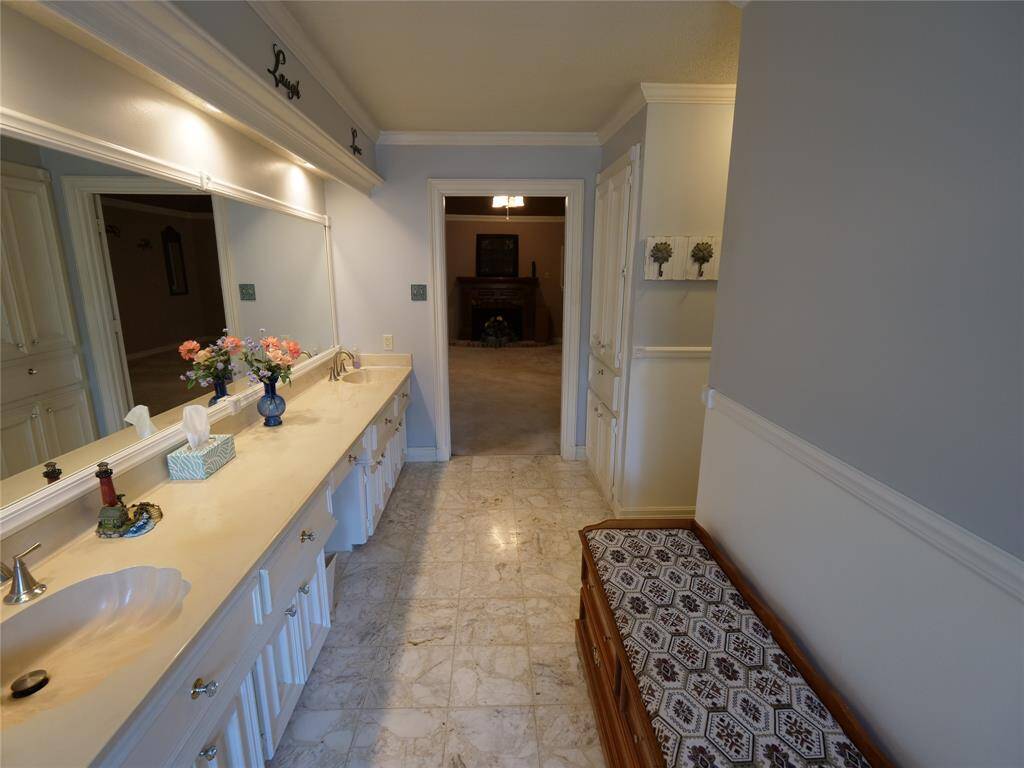 Primary bathroom with primary bedroom and fireplace in view