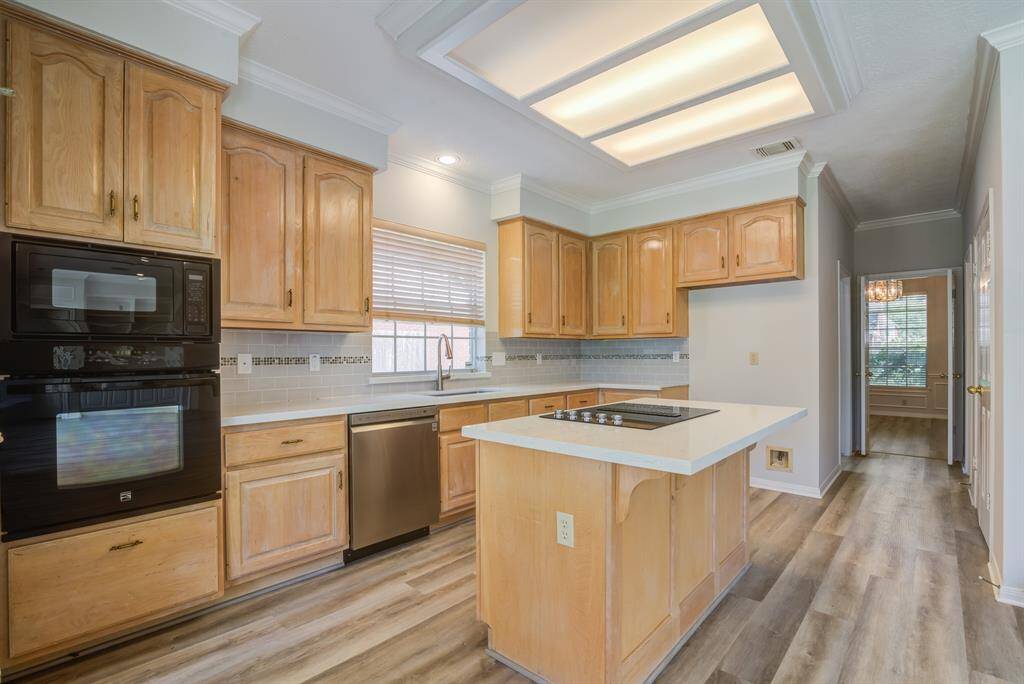 Beautiful white oak finished cabinetry and updated counter tops add to this well laid out kitchen with large pantry and connection to dining space.