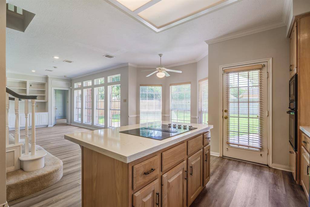 Rear door allows easy access to garage for bringing in the groceries. Notice the abundance of windows.