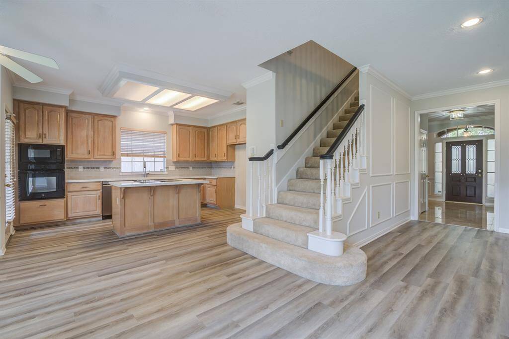 Stairway to second level has a well designed location facing to the rear of the home, and situated between the kitchen and living space.