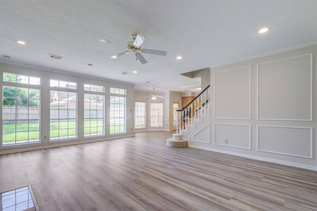 Spacious and light filled living area with freshly painted walls complete with trim for an elegant style. Updated plank flooring throughout the first level.