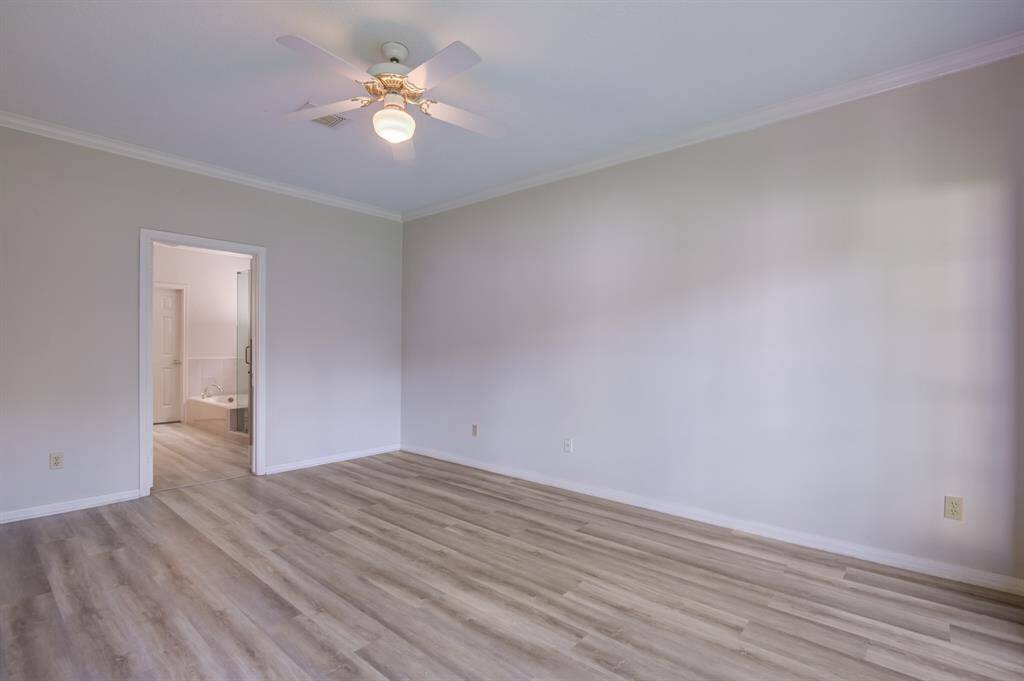 First level primary bedroom with entrance to large en suite and two walk in closets.