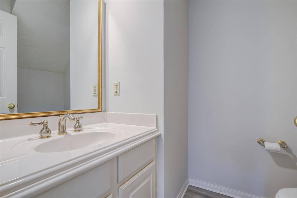 Powder room for first level of home discretely tucked between kitchen and dining rooms.