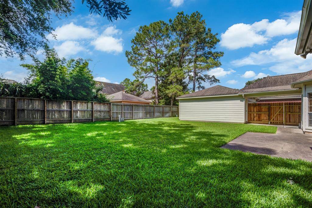 Fully fenced back yard with green space and patio. Room for a pool!