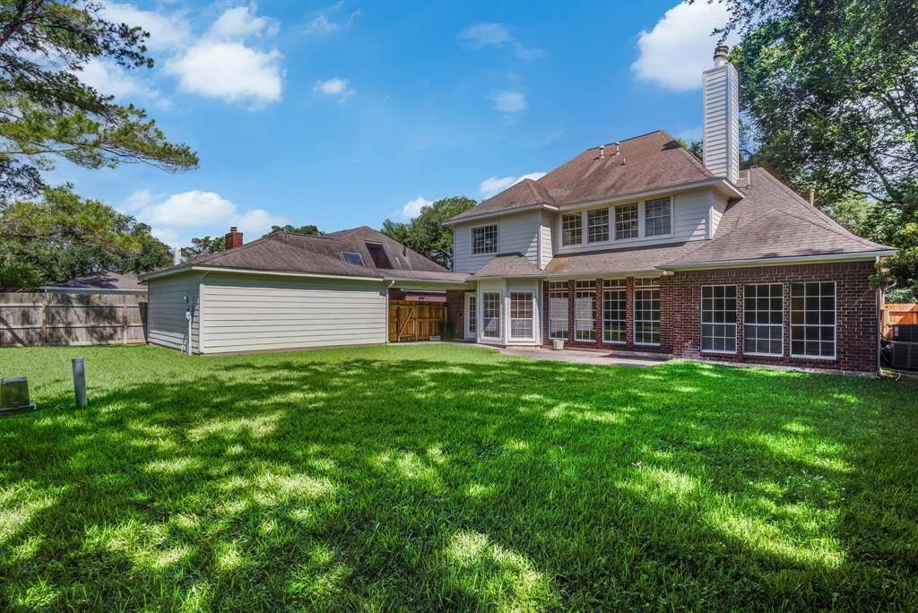 View of home from back of yard. Notice the beautiful elegant look of this home with all its windows.