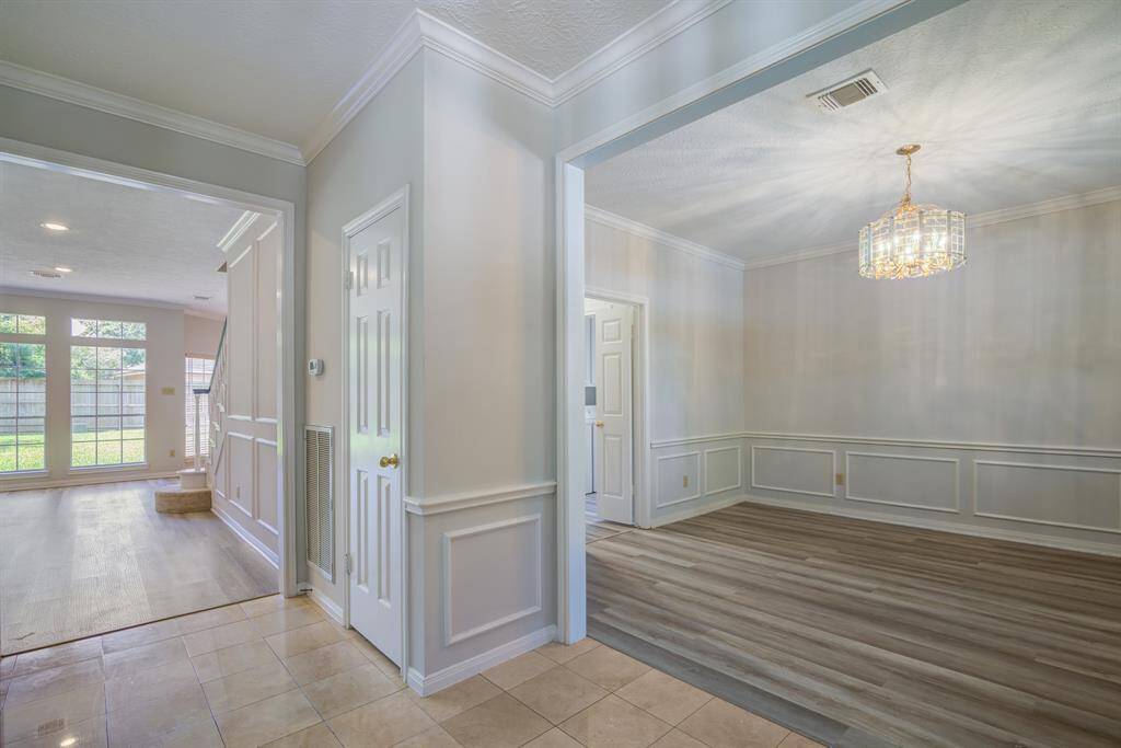 Convenient coat closet in entryway and entrances to formal dining and living space. See all the way through to rear yard.