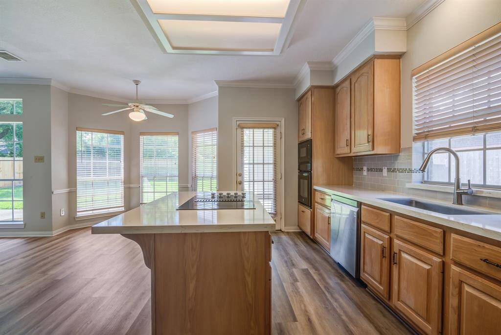 Beautiful updated kitchen with quartz counter tops, breakfast bat island, updated cook top, and large, deep sink.