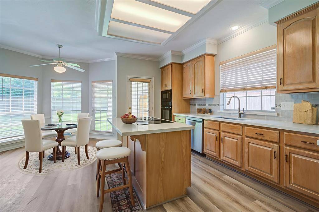 Virtually Staged. This beautiful open kitchen is filled with natural light and has room for additional casual dining table with, view of the rear yard.