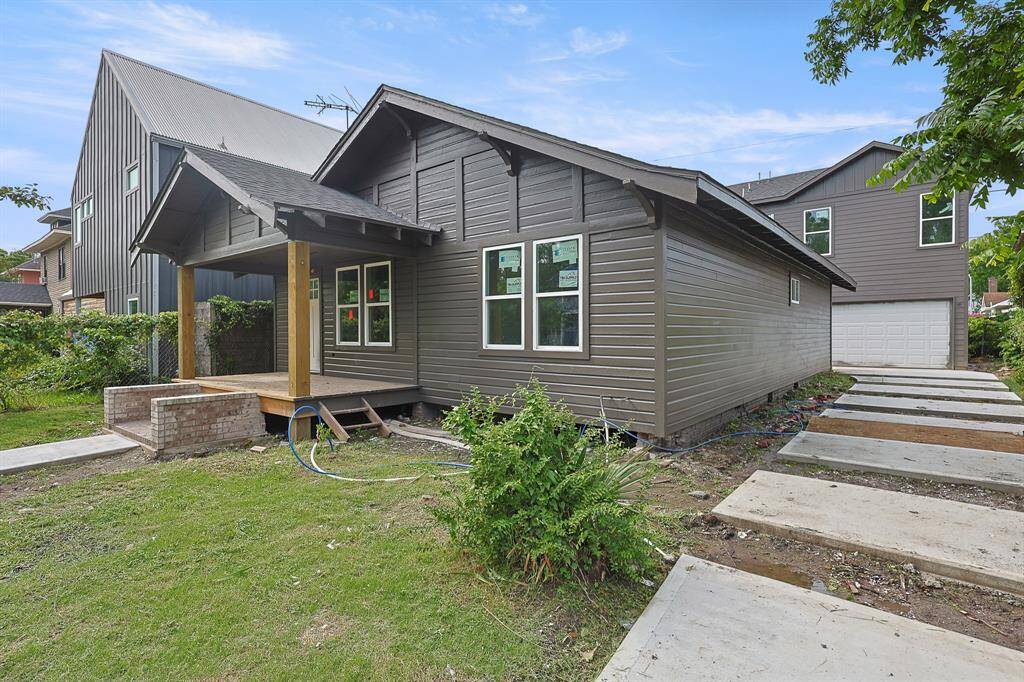 Freshly painted in a sleek matte black, this modernized exterior is making a bold statement. A classic brick staircase leads to a welcoming front porch, while the spacious front yard and extended driveway provide ample curb appeal and convenient access to the detached garage in the rear. This home is undergoing a stunning renovation—progress you can already see from the street!